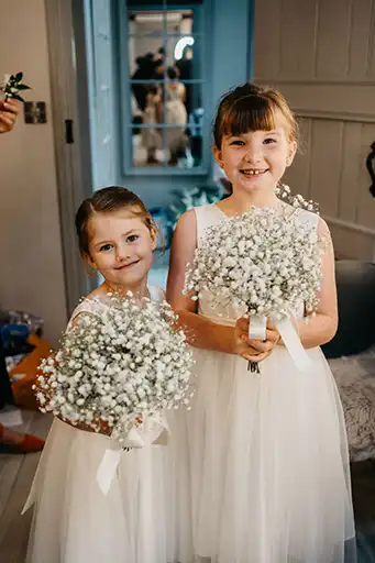 Flower girls holding gypsophila bouquets at Charlotte and Curt's Blackwell Grange wedding.